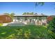 Large, grassy backyard showcasing a shed, a freshly painted patio, and plenty of natural light at 2311 Wintergreen Pl, Durham, NC 27707