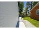 Spacious fenced yard including a gray painted brick patio and a walkway on a lush lawn at 2311 Wintergreen Pl, Durham, NC 27707
