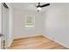 Bright bedroom featuring sleek laminated floors, a window, and a contemporary ceiling fan at 2311 Wintergreen Pl, Durham, NC 27707