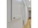 Hallway view featuring hardwood floors, fresh paint, and ample lighting at 2311 Wintergreen Pl, Durham, NC 27707
