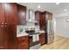 Modern kitchen features stainless appliances, wood cabinets, white subway tile, and light flooring at 2311 Wintergreen Pl, Durham, NC 27707