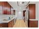 Modern kitchen featuring hardwood floors, white countertops, stainless steel appliances, and dark wood cabinets at 2311 Wintergreen Pl, Durham, NC 27707