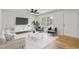 Bright living room with a ceiling fan, accent chairs, and modern decor at 2311 Wintergreen Pl, Durham, NC 27707