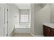 Bright bathroom featuring a soaking tub under a window and neutral wall color at 245 Kylemore Cir, Cary, NC 27513