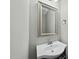 Small bathroom with a white vanity and sink, and a silver-framed mirror with vanity lighting at 245 Kylemore Cir, Cary, NC 27513