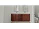 Bathroom with double sink vanity, framed mirrors, and dark wood cabinets at 245 Kylemore Cir, Cary, NC 27513