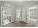 Hallway with carpet flooring, access to laundry and bedroom at 245 Kylemore Cir, Cary, NC 27513