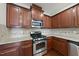 Well-equipped kitchen with stainless steel appliances, granite countertops, and ample cabinet space at 245 Kylemore Cir, Cary, NC 27513
