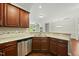 Functional kitchen with stainless steel appliances, tile backsplash, and granite counters at 245 Kylemore Cir, Cary, NC 27513