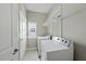 Functional laundry area boasts a full-sized washer, dryer, and convenient overhead shelving at 245 Kylemore Cir, Cary, NC 27513