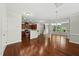 Open concept living space with hardwood floors, and kitchen with granite counters at 245 Kylemore Cir, Cary, NC 27513