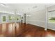 Cozy living area with hardwood floors, fireplace, shelving, and a door leading to the backyard at 245 Kylemore Cir, Cary, NC 27513