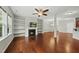 Open concept living room has hardwood floors, fireplace with built-in shelves, and lots of space to relax and unwind at 245 Kylemore Cir, Cary, NC 27513
