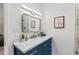 Bathroom featuring a blue vanity with a marble countertop at 2508 Sevier St, Durham, NC 27705