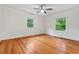Bedroom featuring hardwood floors and two windows at 2508 Sevier St, Durham, NC 27705