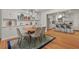 Open dining area featuring modern chandelier, hardwood floors, and built-in shelving at 2508 Sevier St, Durham, NC 27705