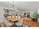 Bright dining area with hardwood floors, open to living area and featuring modern light fixture at 2508 Sevier St, Durham, NC 27705