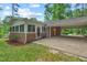 A brick house features a screened-in porch and a covered carport at 2508 Sevier St, Durham, NC 27705