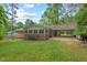 A single-story brick home with a well-manicured lawn and covered carport at 2508 Sevier St, Durham, NC 27705
