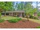 Charming brick home with a well-manicured lawn and mature trees creating an inviting curb appeal at 2508 Sevier St, Durham, NC 27705