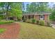 Beautiful brick home with lush green lawn and mature landscaping adding to the home's curb appeal at 2508 Sevier St, Durham, NC 27705