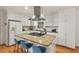 Well-lit kitchen with stainless steel appliances, granite counters, and island seating at 2508 Sevier St, Durham, NC 27705