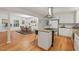 Open-concept kitchen and dining area with stainless hood, white cabinets and hardwood floors at 2508 Sevier St, Durham, NC 27705