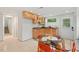 Well-lit kitchen with light-colored cabinets, granite countertops, and a charming dining space at 2508 Sevier St, Durham, NC 27705
