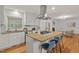 Spacious kitchen with island cooktop, granite counters, and stainless-steel hood at 2508 Sevier St, Durham, NC 27705