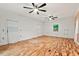 Bright, spacious room with hardwood floors, white shiplap walls, and modern ceiling fans at 2508 Sevier St, Durham, NC 27705
