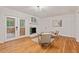 Bright living room featuring fireplace, access to porch, hardwood floors, neutral decor at 2508 Sevier St, Durham, NC 27705