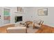 Bright living room with fireplace, access to enclosed porch, hardwood floors, and neutral decor at 2508 Sevier St, Durham, NC 27705