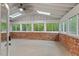 Enclosed sunroom featuring skylights and windows that offer views of the beautiful yard at 2508 Sevier St, Durham, NC 27705