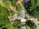 Aerial view of property showcasing the home, expansive backyard, deck, patio, and mature trees at 2529 Remington Rd, Raleigh, NC 27610