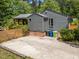 The back of the home features a brick foundation, wood siding, and a spacious parking pad at 2529 Remington Rd, Raleigh, NC 27610