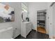 Modern bathroom features a sleek vanity, round mirror, and a walk-in closet for ample storage at 2529 Remington Rd, Raleigh, NC 27610