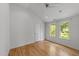 Bright bedroom features hardwood floors, a ceiling fan, and windows with natural light at 2529 Remington Rd, Raleigh, NC 27610