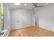 Bright and airy bedroom with hardwood floors, a ceiling fan, and access to an ensuite bathroom at 2529 Remington Rd, Raleigh, NC 27610
