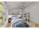 Bright bedroom features hardwood floors, ceiling fan, and a large window with great natural light at 2529 Remington Rd, Raleigh, NC 27610