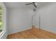 Minimalist bedroom with hardwood floors, a ceiling fan, and view of the backyard at 2529 Remington Rd, Raleigh, NC 27610