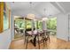 Bright dining area with modern lighting and sliding doors to screened porch, perfect for entertaining at 2529 Remington Rd, Raleigh, NC 27610