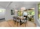 Bright dining area with modern lighting, wood floors, and sliding doors to a screened in porch at 2529 Remington Rd, Raleigh, NC 27610