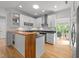 Contemporary kitchen featuring a breakfast bar, sleek white cabinets, and stainless steel appliances at 2529 Remington Rd, Raleigh, NC 27610