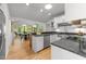 Modern kitchen with stainless steel appliances, quartz counters, and an adjacent dining area at 2529 Remington Rd, Raleigh, NC 27610