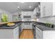 Modern kitchen with white cabinetry, stainless steel appliances, and stylish hardwood floors at 2529 Remington Rd, Raleigh, NC 27610