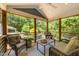 Cozy outdoor living space with comfortable seating, natural light, and a view of the backyard at 2529 Remington Rd, Raleigh, NC 27610