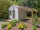 A quaint white shed with a pergola and garden bed, perfect for storage or a workshop at 2529 Remington Rd, Raleigh, NC 27610
