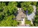 Aerial view of a charming home with lush greenery, a large driveway, and an outdoor patio area at 2613 Bedford Ave, Raleigh, NC 27607