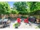 The backyard features a stone patio, fire pit, seating, and lush greenery surrounding the area at 2613 Bedford Ave, Raleigh, NC 27607