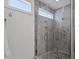 Modern bathroom with frameless glass shower and pebble flooring at 2613 Bedford Ave, Raleigh, NC 27607